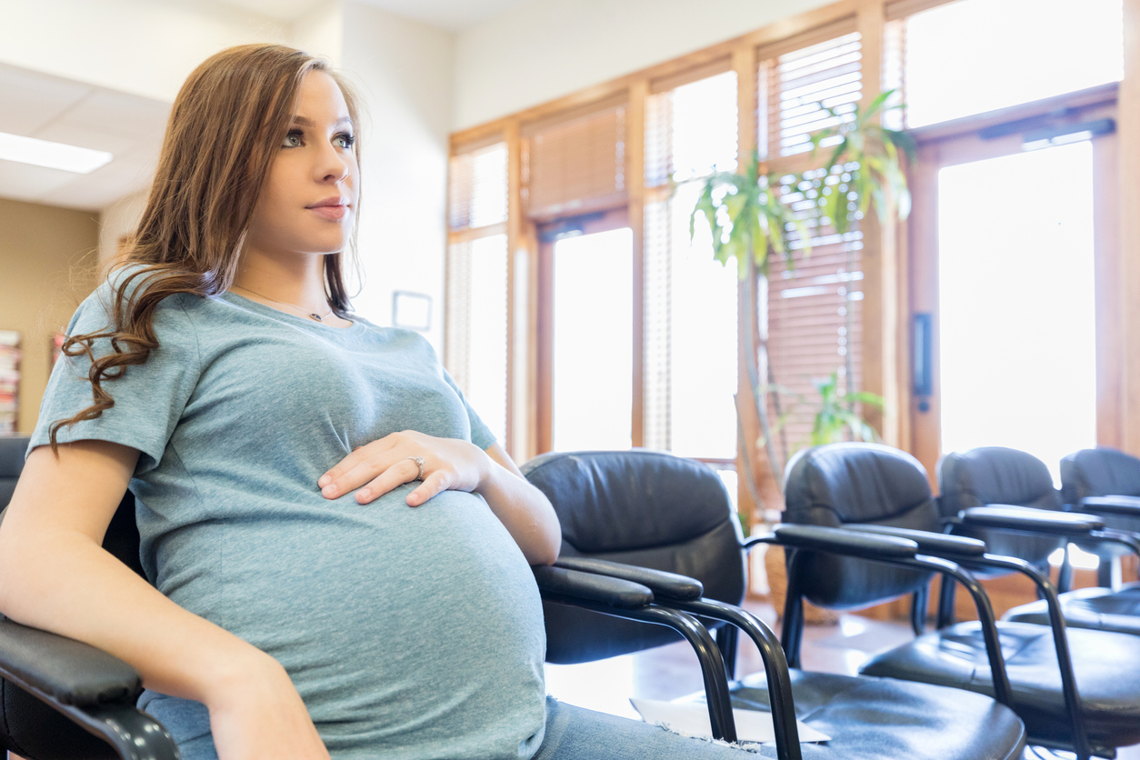 Pregnant woman sitting in waiting room